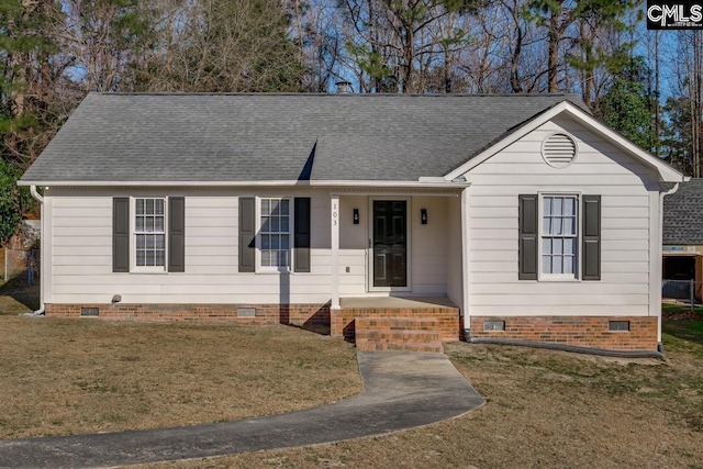 ranch-style house with a front yard and covered porch