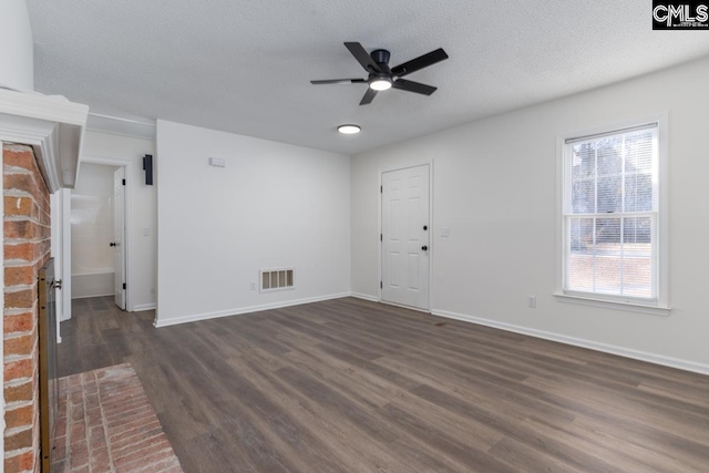 spare room featuring ceiling fan, a textured ceiling, and dark hardwood / wood-style flooring