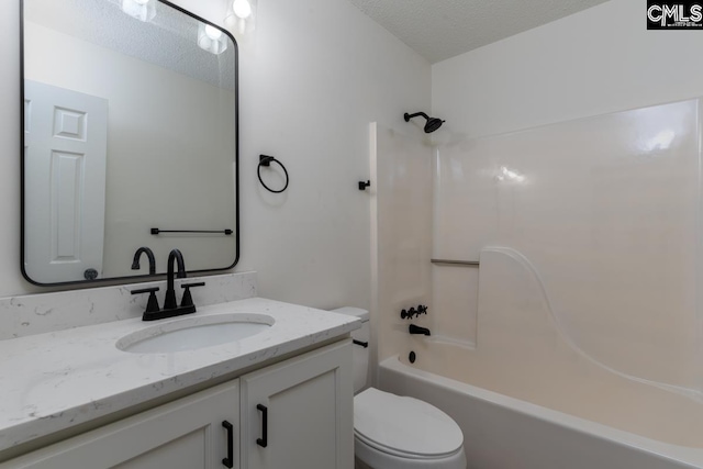 full bathroom with vanity,  shower combination, toilet, and a textured ceiling