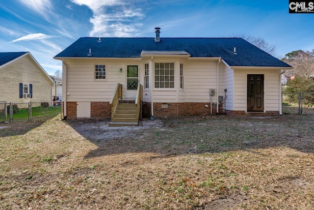 rear view of property with a yard