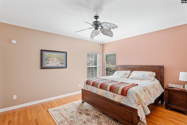 bedroom with ornamental molding, light wood-type flooring, and ceiling fan