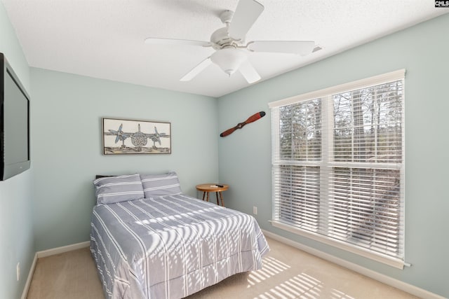 bedroom with ceiling fan and light colored carpet