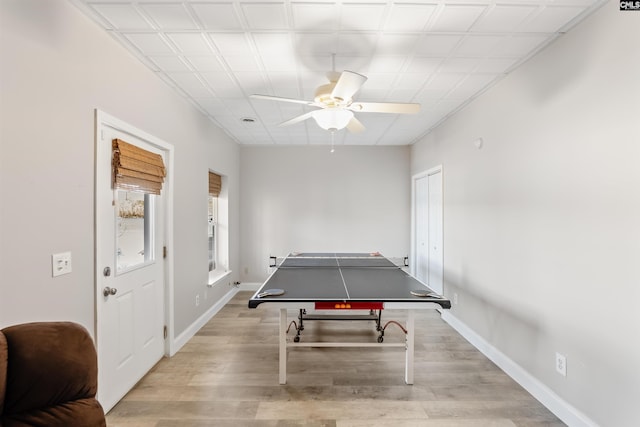 playroom with ceiling fan and light hardwood / wood-style floors