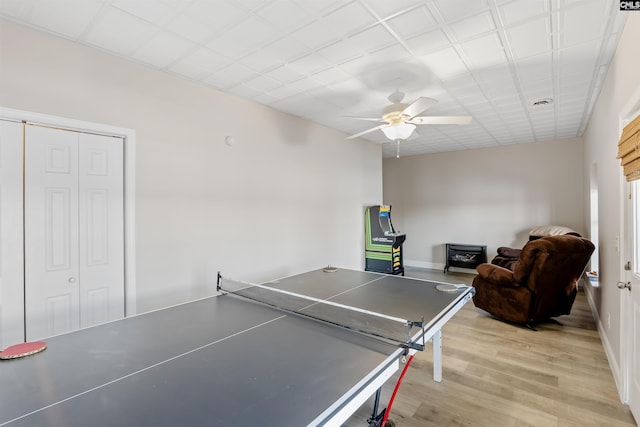 recreation room with ceiling fan and light wood-type flooring