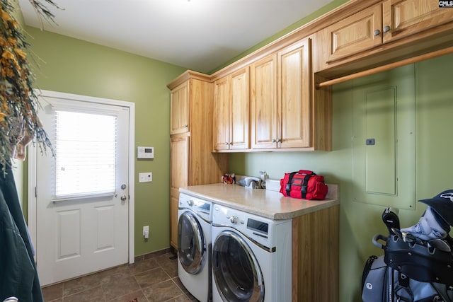 laundry room featuring cabinets and washer and clothes dryer