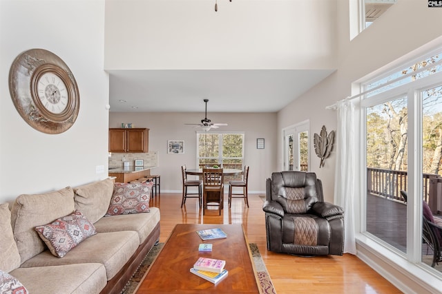 living room with ceiling fan and light hardwood / wood-style floors