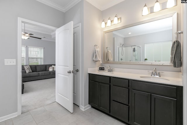 bathroom with crown molding, ceiling fan, vanity, and a shower with shower door