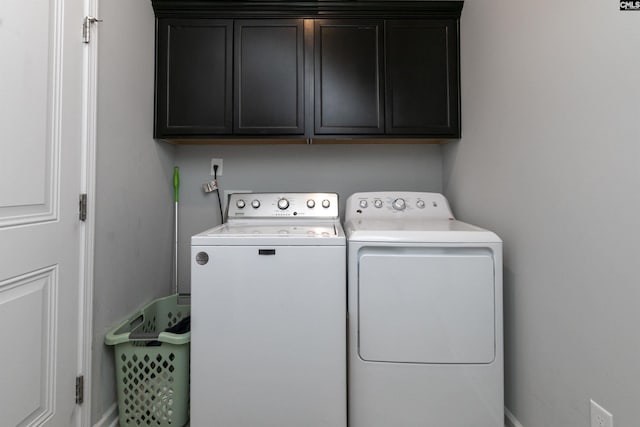 laundry area featuring cabinets and separate washer and dryer