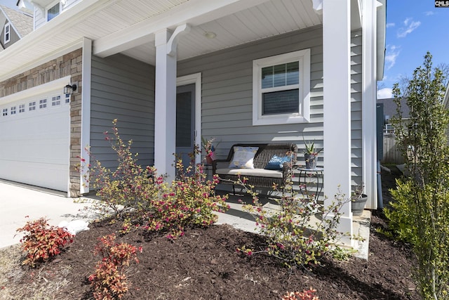 view of property exterior featuring a garage and covered porch