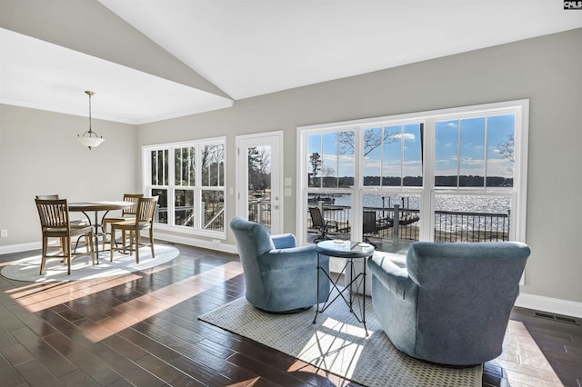 living room with a water view, dark hardwood / wood-style flooring, and vaulted ceiling