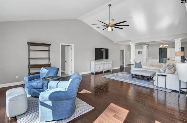 living room featuring ceiling fan with notable chandelier, vaulted ceiling, and decorative columns