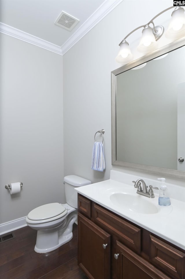 bathroom featuring ornamental molding, vanity, toilet, and hardwood / wood-style floors