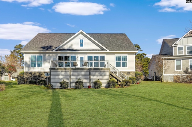 back of house featuring a wooden deck and a yard