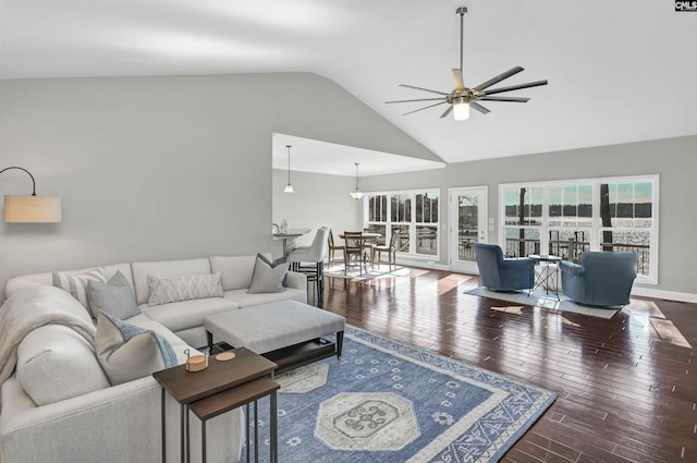 living room with dark wood-type flooring, ceiling fan, and lofted ceiling