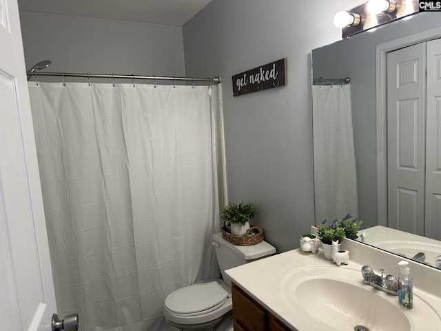 bathroom with vanity, toilet, and walk in shower