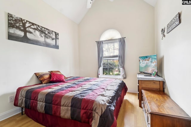 bedroom with vaulted ceiling and light hardwood / wood-style flooring