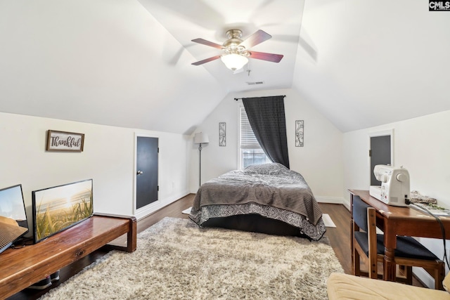 bedroom with dark wood-type flooring, ceiling fan, and vaulted ceiling