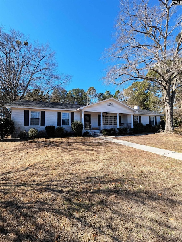 ranch-style house with covered porch and a front yard