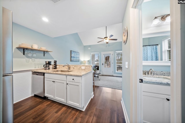 kitchen featuring dishwasher, sink, dark wood-type flooring, and white cabinets