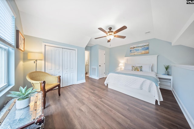 bedroom featuring dark hardwood / wood-style flooring, lofted ceiling, a closet, and ceiling fan