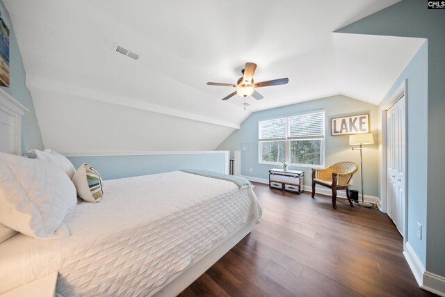 bedroom featuring dark hardwood / wood-style flooring, vaulted ceiling, a closet, and ceiling fan