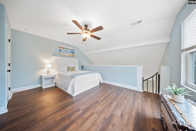 bedroom with vaulted ceiling, dark wood-type flooring, and ceiling fan