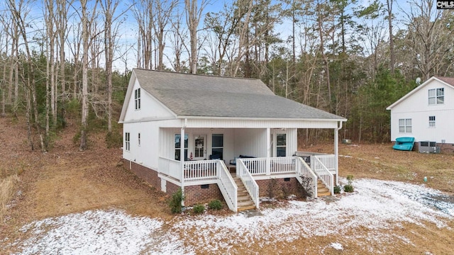 view of front of property featuring cooling unit and covered porch