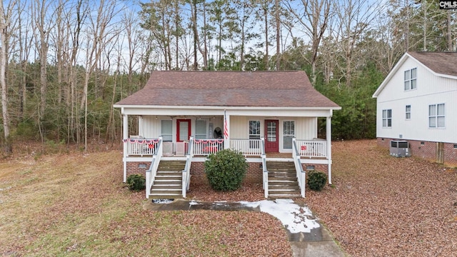 bungalow-style house featuring a porch and central AC