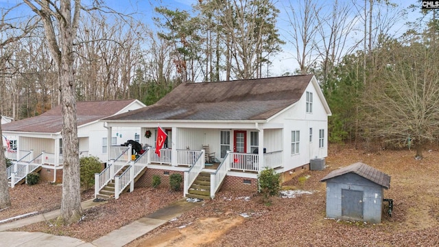 bungalow featuring central AC, a storage shed, and covered porch