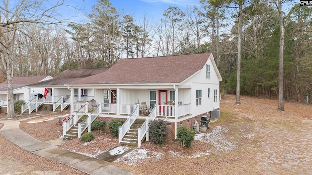 view of front of property featuring cooling unit and covered porch