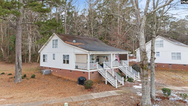 view of front of home with central AC and a porch