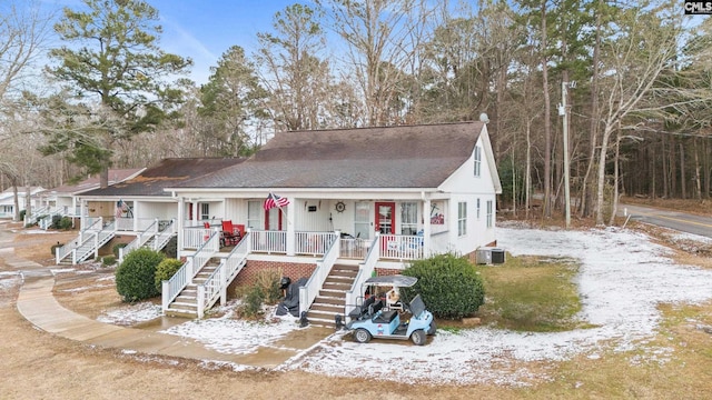 view of front of property with cooling unit and a porch