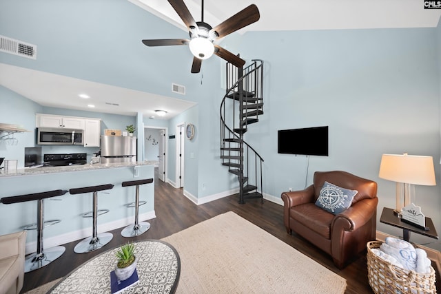 living room featuring dark hardwood / wood-style flooring and vaulted ceiling