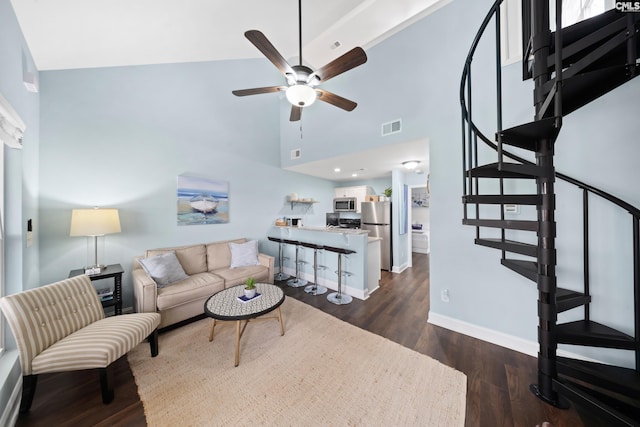 living room with ceiling fan, dark hardwood / wood-style flooring, and high vaulted ceiling