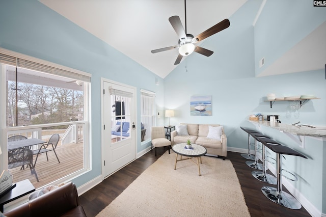 living room featuring dark wood-type flooring, ceiling fan, and lofted ceiling