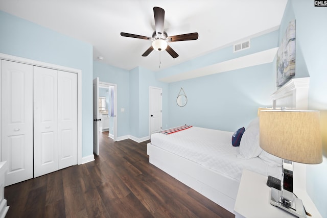 bedroom with dark hardwood / wood-style floors, a closet, and ceiling fan