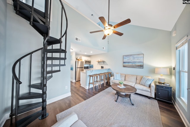 living room with ceiling fan, dark hardwood / wood-style floors, and high vaulted ceiling