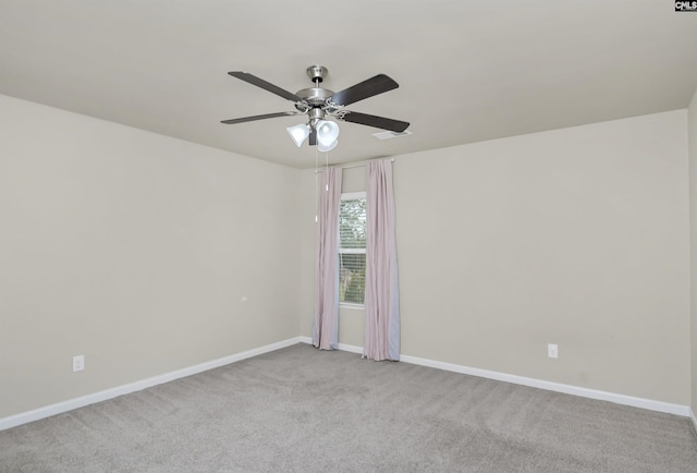 spare room featuring ceiling fan and light carpet