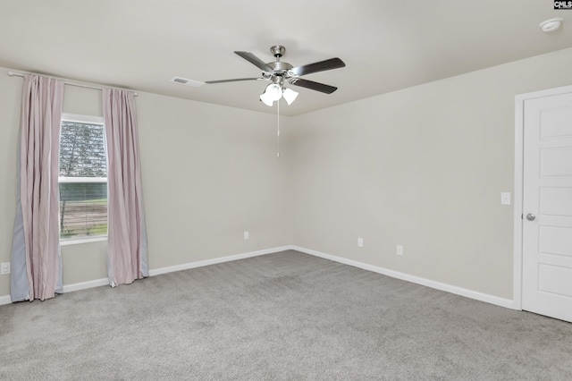 carpeted spare room featuring ceiling fan