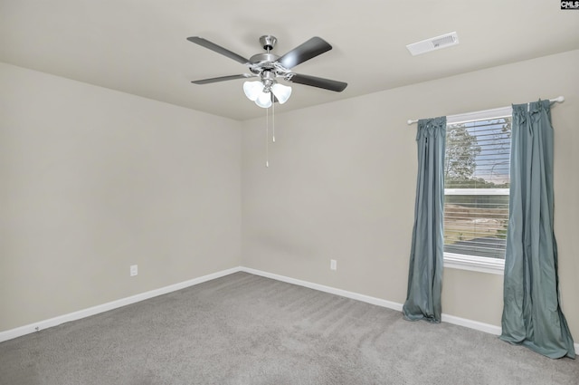 carpeted empty room featuring ceiling fan