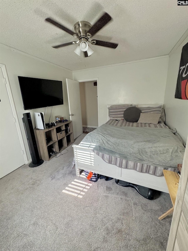 carpeted bedroom featuring ceiling fan and a textured ceiling