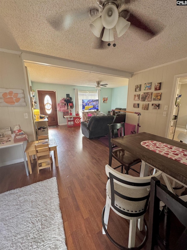 dining room with hardwood / wood-style flooring, ornamental molding, a textured ceiling, and ceiling fan