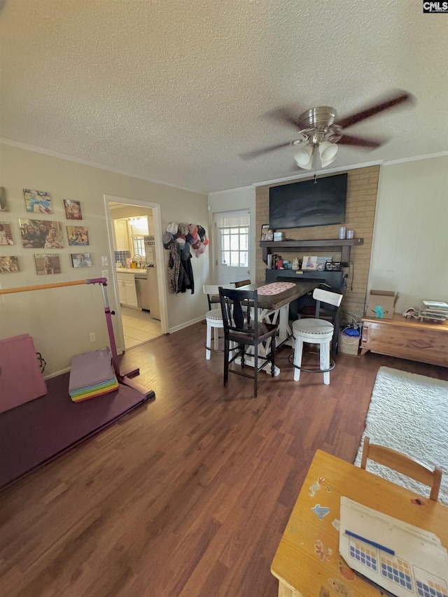 interior space with ceiling fan, crown molding, wood-type flooring, and a textured ceiling