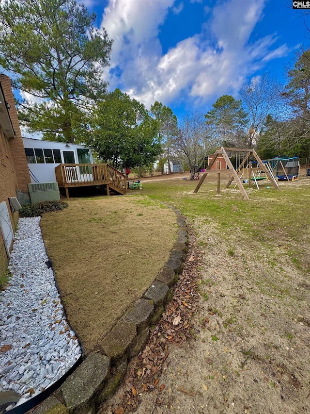 view of yard with a deck and a playground