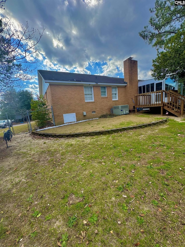 back of house featuring a yard and cooling unit