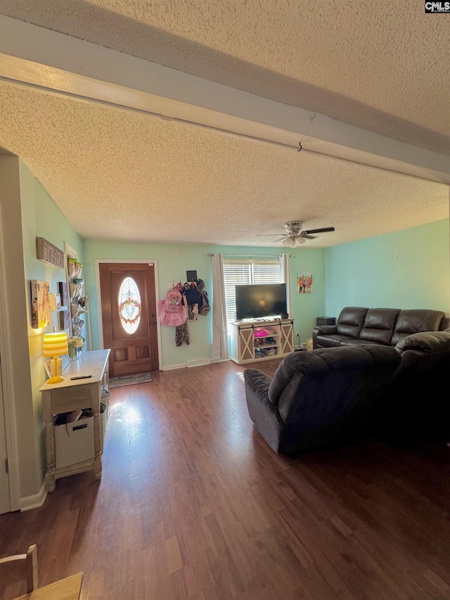 living room featuring ceiling fan, a healthy amount of sunlight, hardwood / wood-style floors, and a textured ceiling