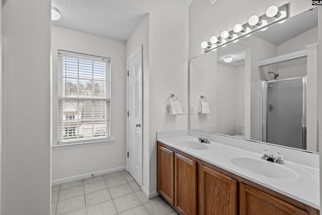 bathroom featuring tile patterned floors, toilet, a shower with shower door, and a wealth of natural light