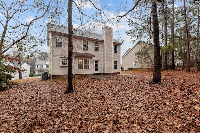 rear view of house with cooling unit and a patio