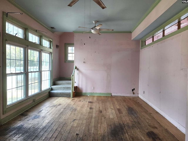 unfurnished room with ornamental molding, plenty of natural light, hardwood / wood-style floors, and ceiling fan