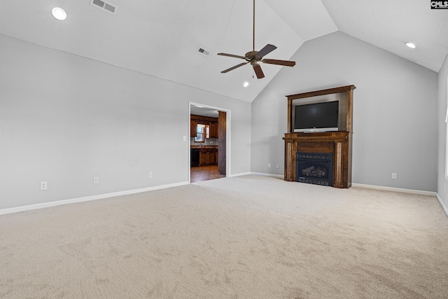 unfurnished living room with vaulted ceiling, ceiling fan, and carpet